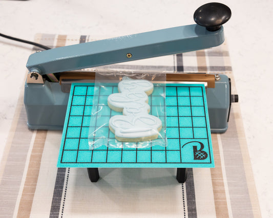 Heat seal table with removable legs and storage compartment